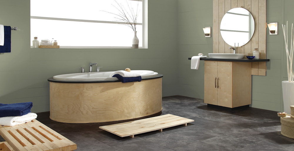 contemporary green bathroom with pale-wood vanity and oval bathtub.