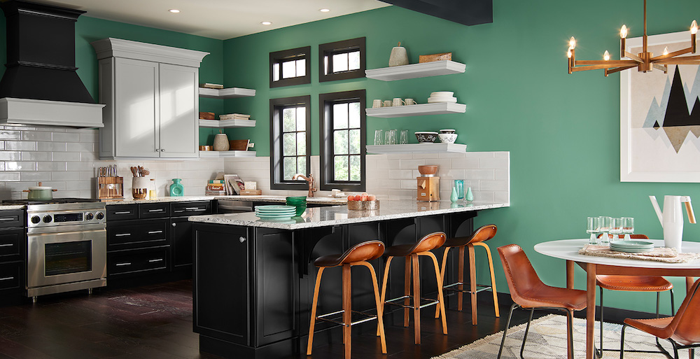 modern green kitchen with white subway tiles and black cabinets