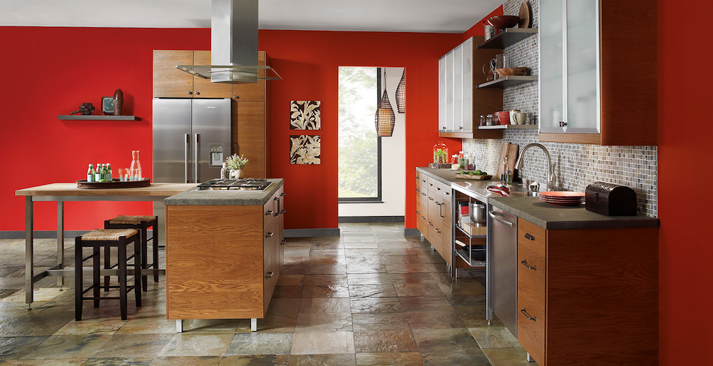vibrant red kitchen with wood cabinets and stainless steel appliances
