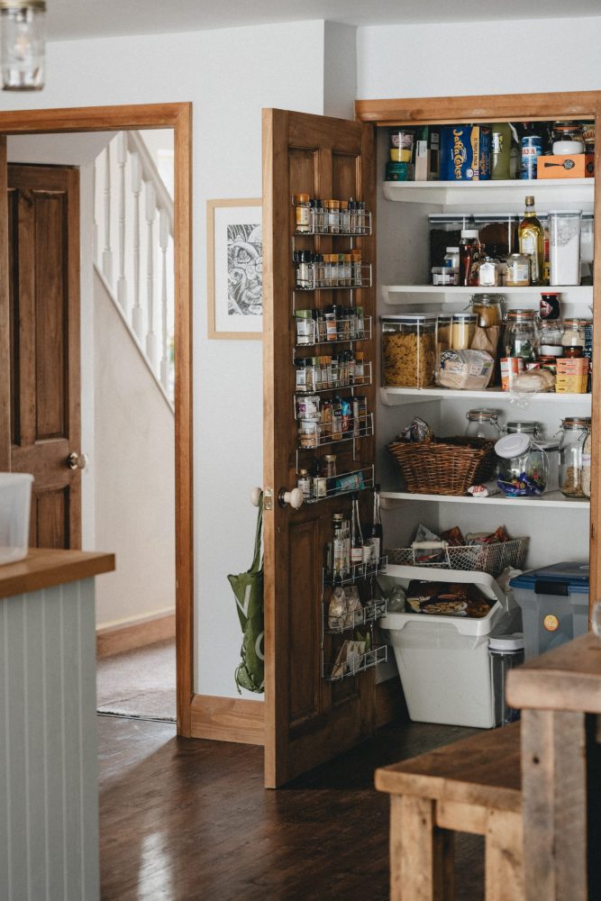 kitchen pantry with spice racks hanging inside door