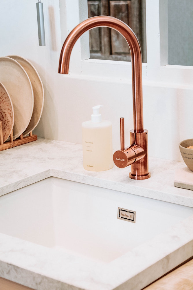 rose-gold kitchen faucet at white sink