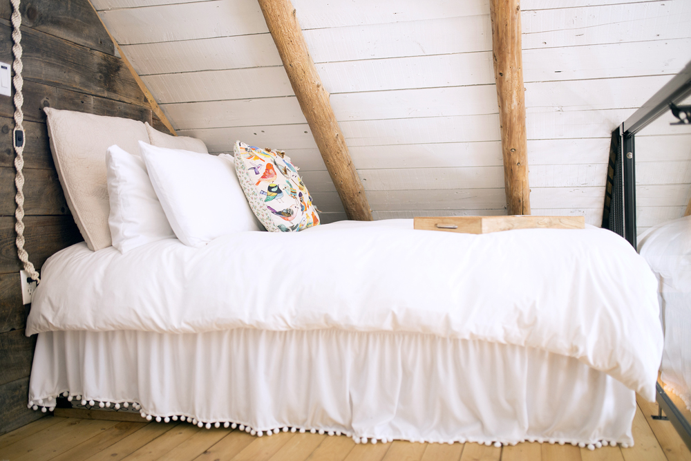 white bed in loft space