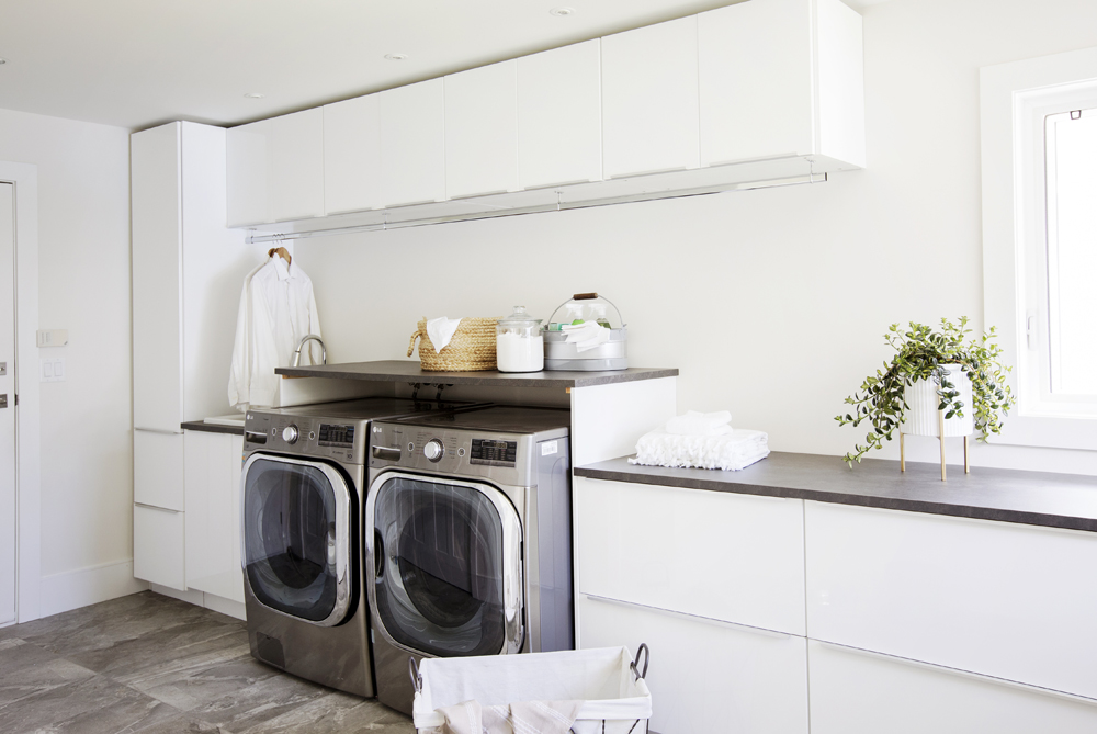 Bright white modern laundry room design.