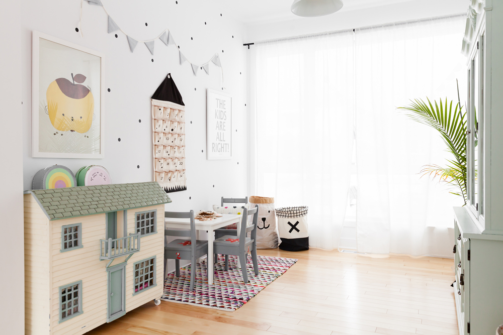 kids playroom with dollhouse on floor, plant to the right