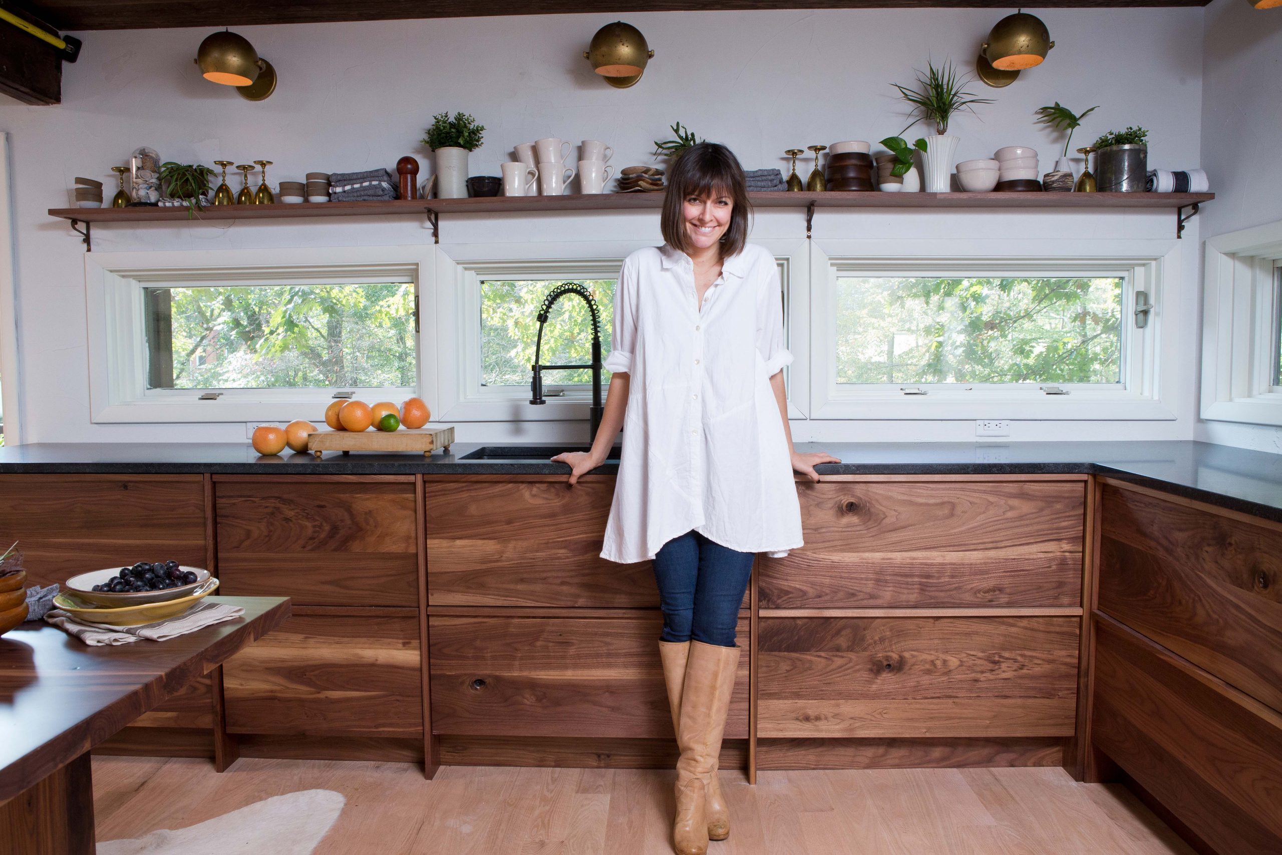 Leanne Ford standing in a renovated kitchen.