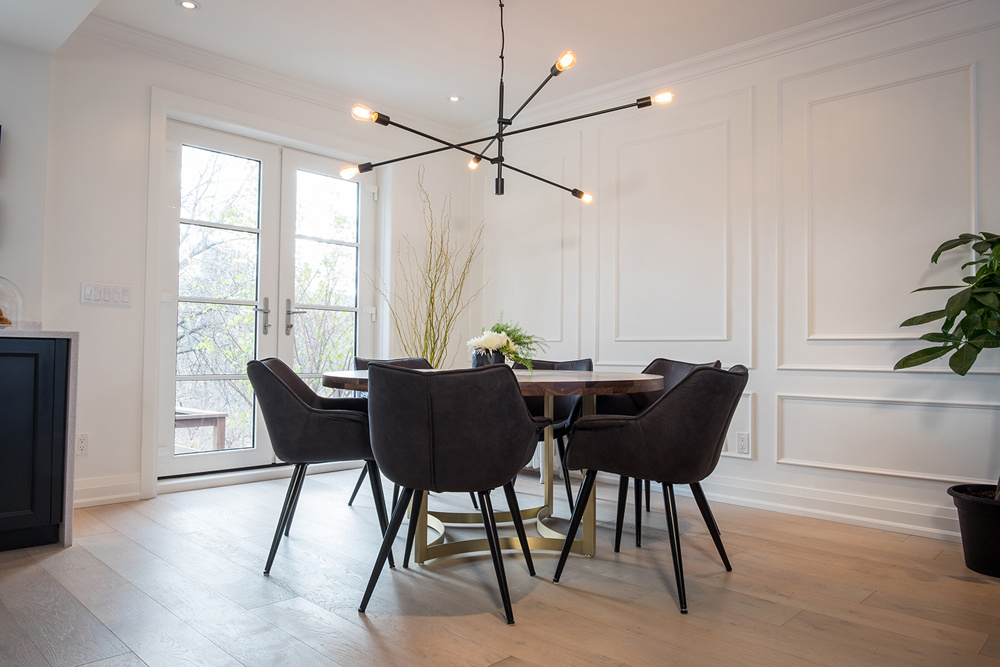 Black matte industrial lighting above a dining room table