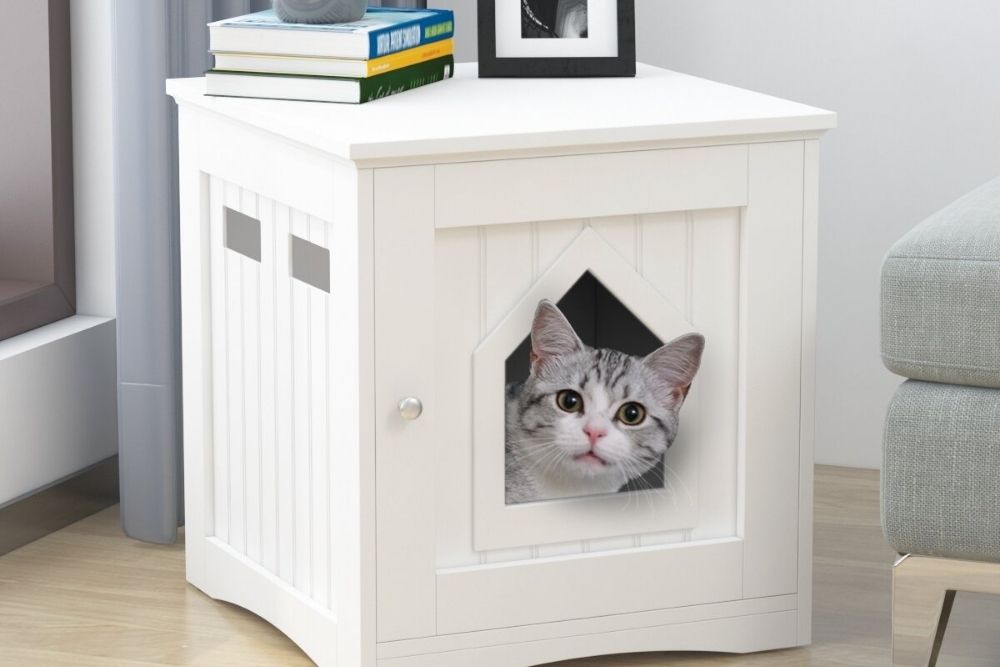 Modern white wood cat litter box sitting in a casual living room