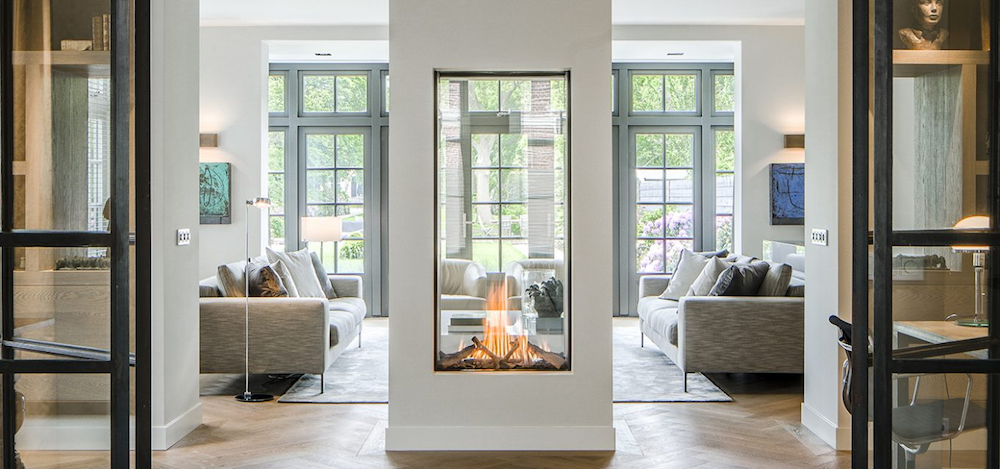 Three-sided glass fireplace in living room