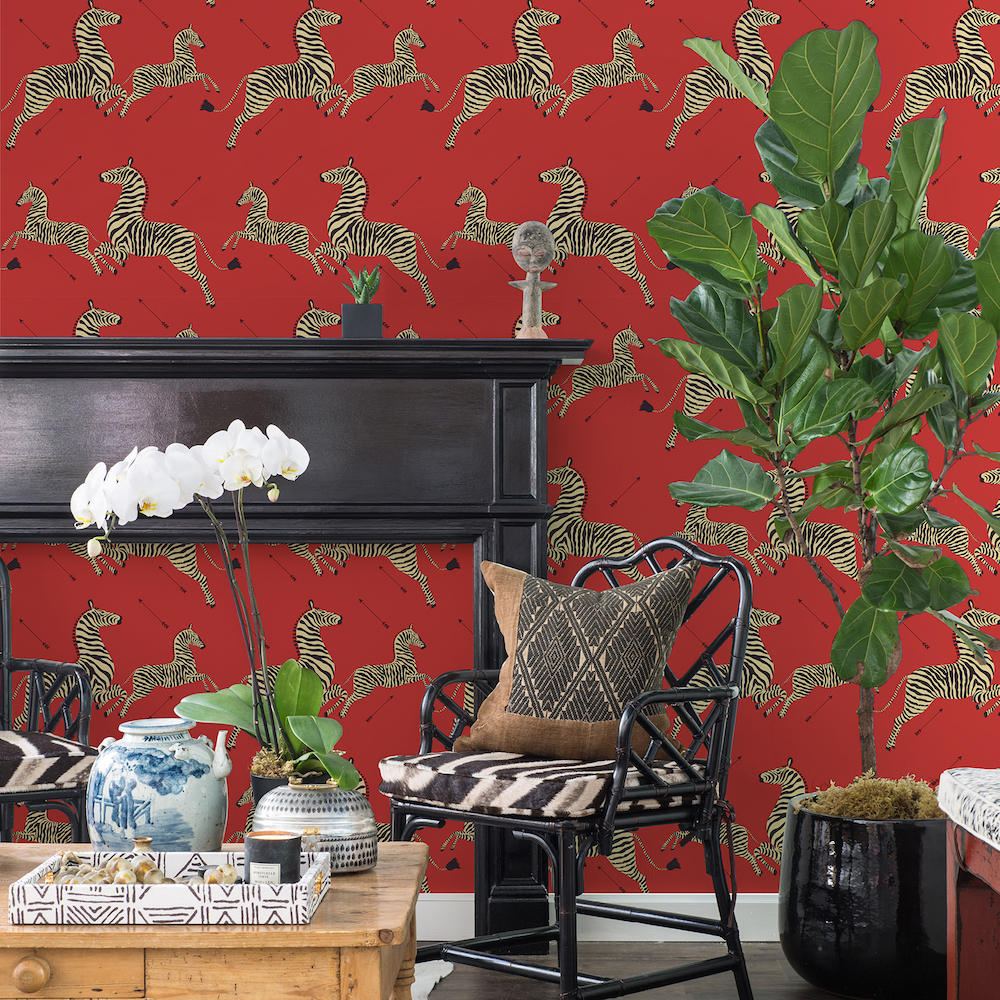 Zebra wallpaper on dramatic red background in living room