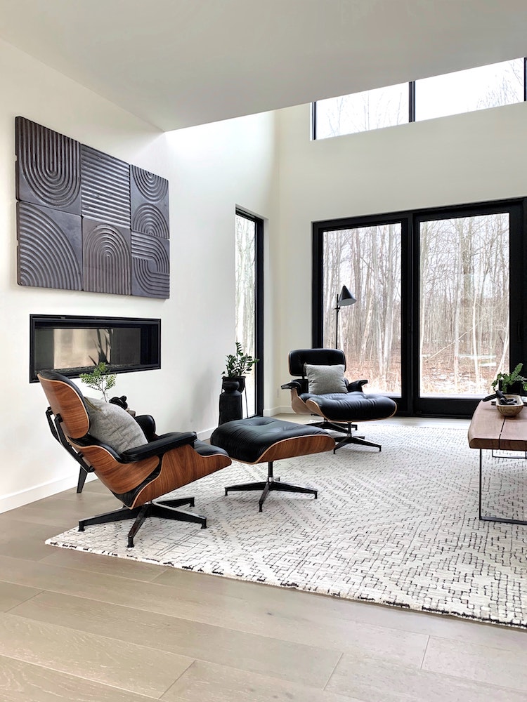 modern white living room with black furniture and patterned area rug