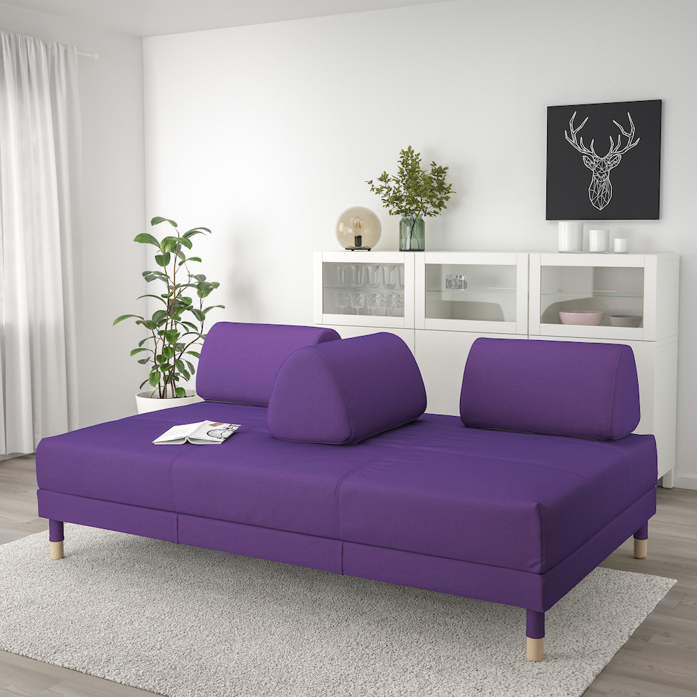Purple sofa in all-white living room
