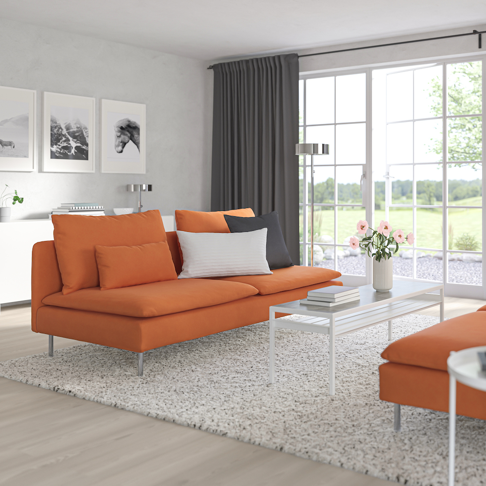 Orange sofa in neutral-toned living room