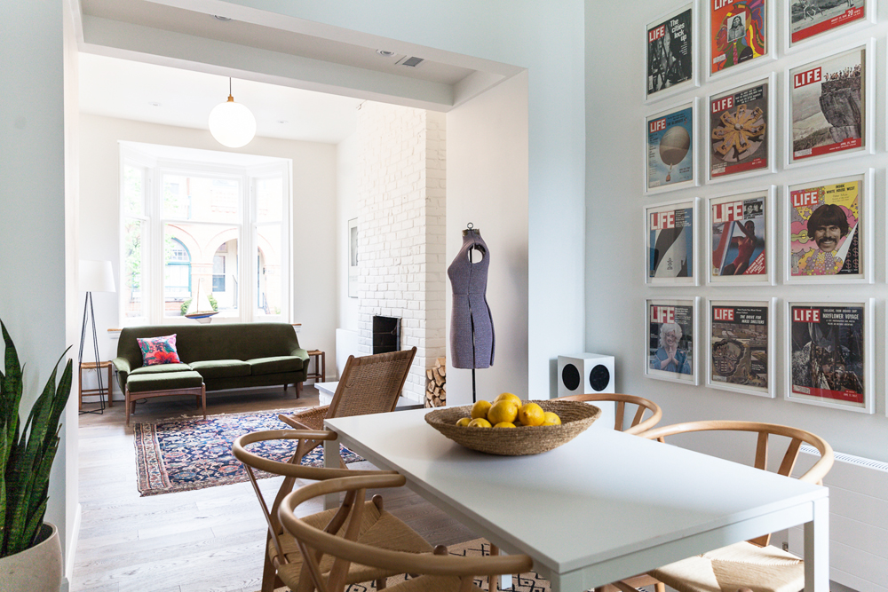A magazine gallery wall in an open-concept dining room space