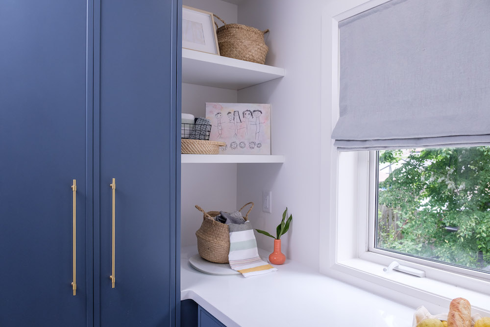 Mud room with storage and blue cabinets