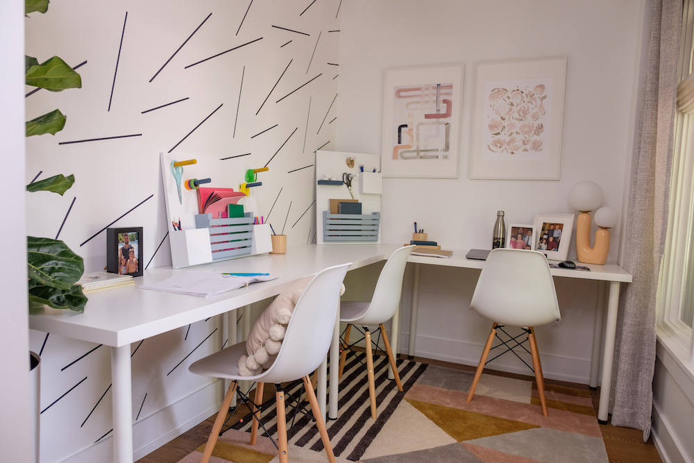 Corner home office with two white desks and chairs