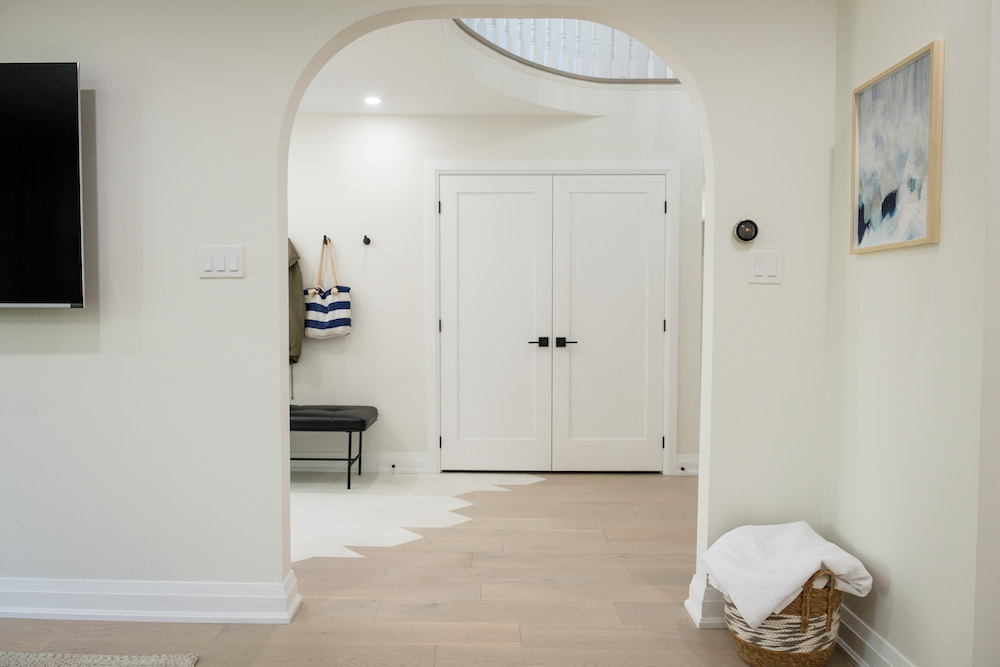 Hardwood floors and white arch wall