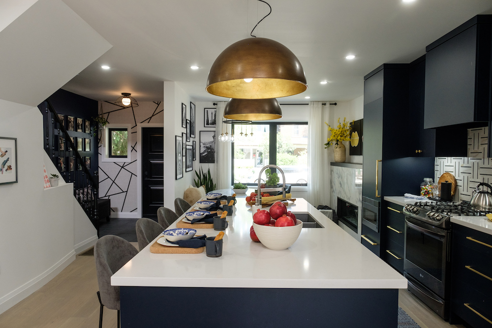 Central kitchen in open concept design with white countertop and dark cabinets