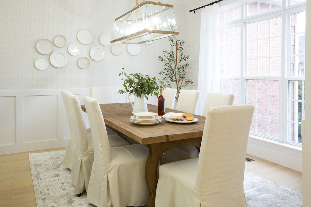 Dining room with white chairs and wooden dining table