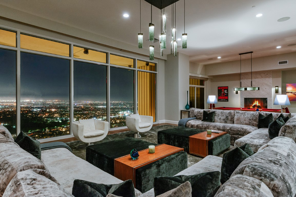 A spacious living room pictured in the evening overlooking the city lights