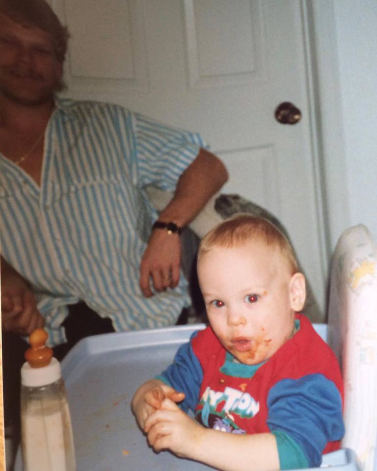 Childhood photo of Mike Holmes Jr with Mike Holmes in the background