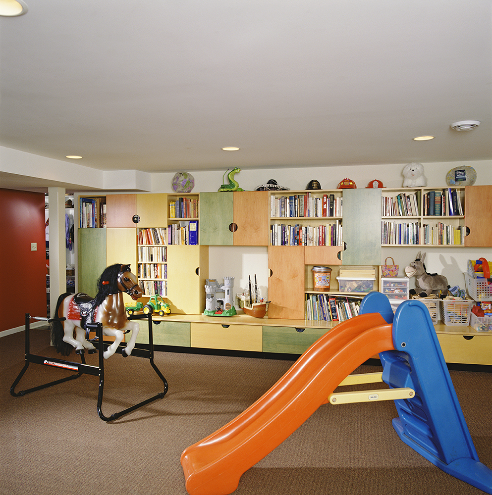 Multicolored Built-in Cabinets in Basement Playroom