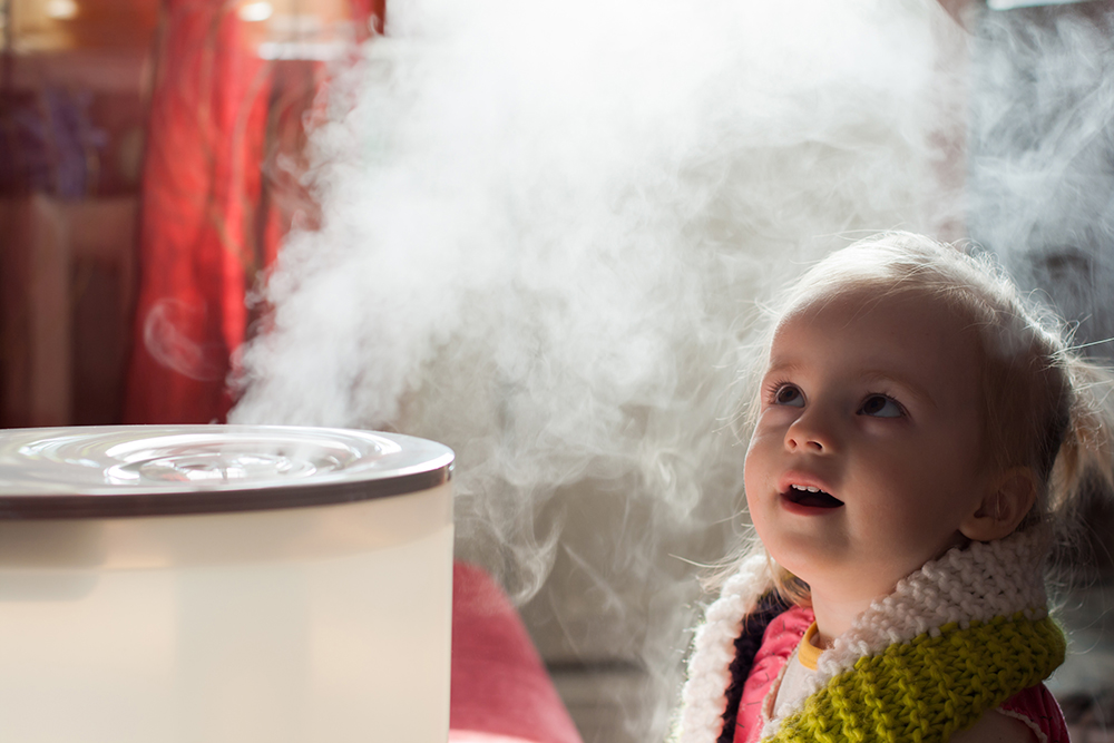 Baby girl mystified by a humidifier