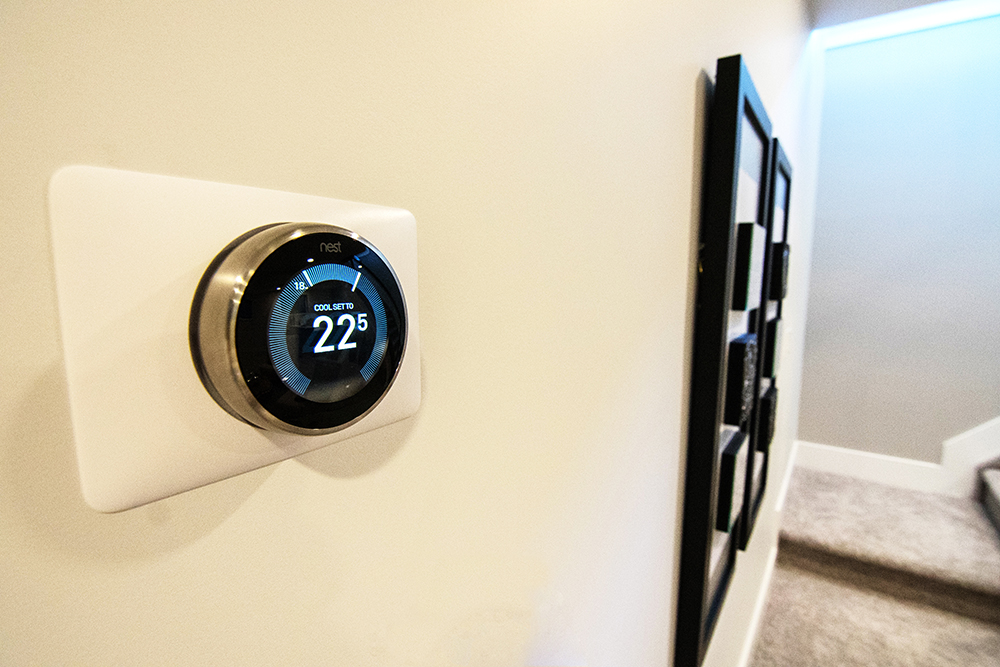 A smart thermostat on a white wall