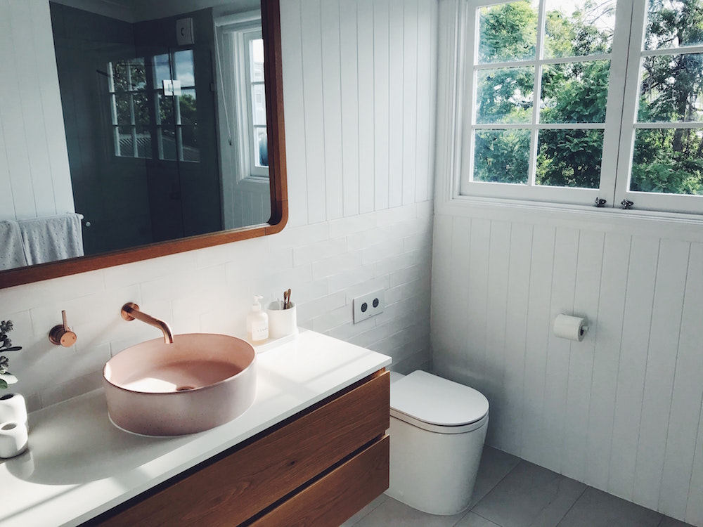 white bathroom with wooden floating vanity and vessel sink