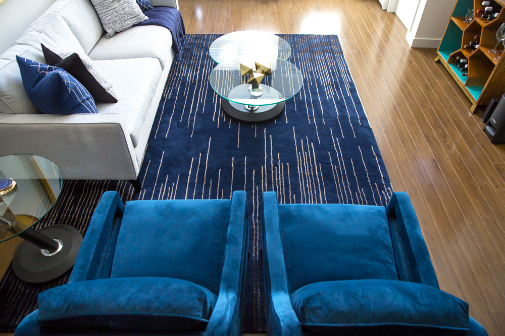 Blue velvet chairs and a blue rug with white strips