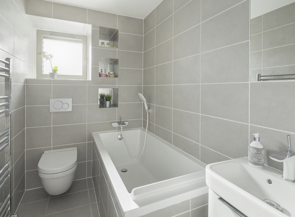 modern grey tiled bathroom with three shower niches