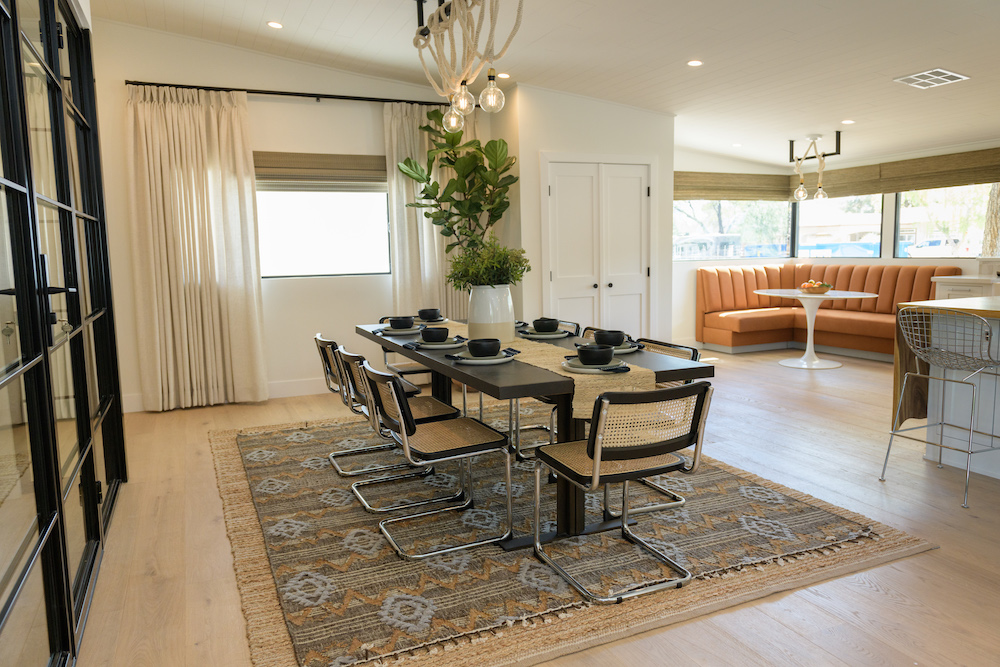 open concept dining room with rope-detail light fixture over large table