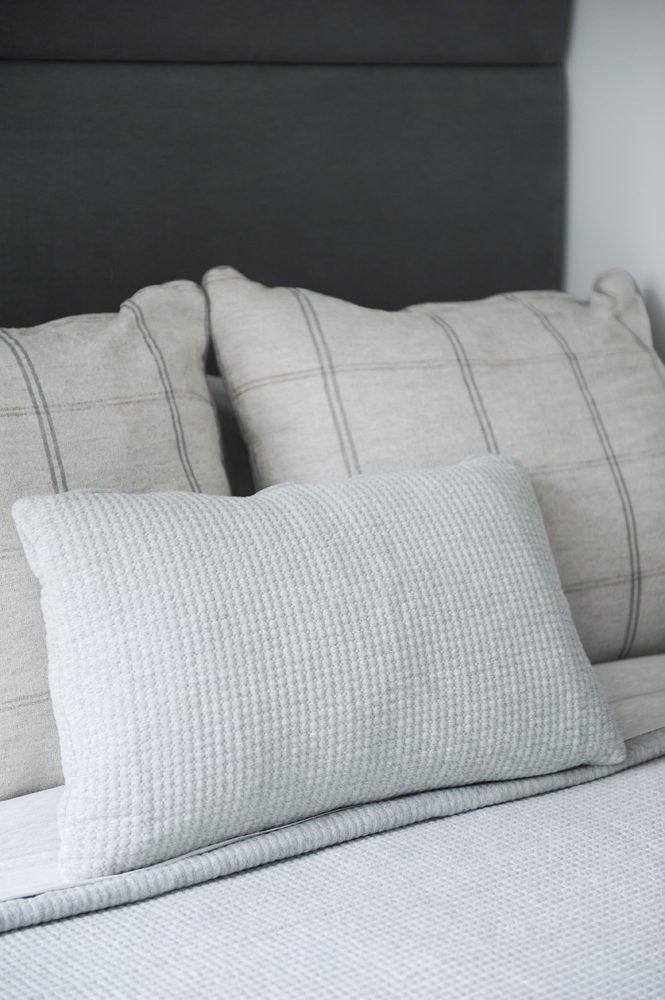 Closeup of three neutral bed cushions