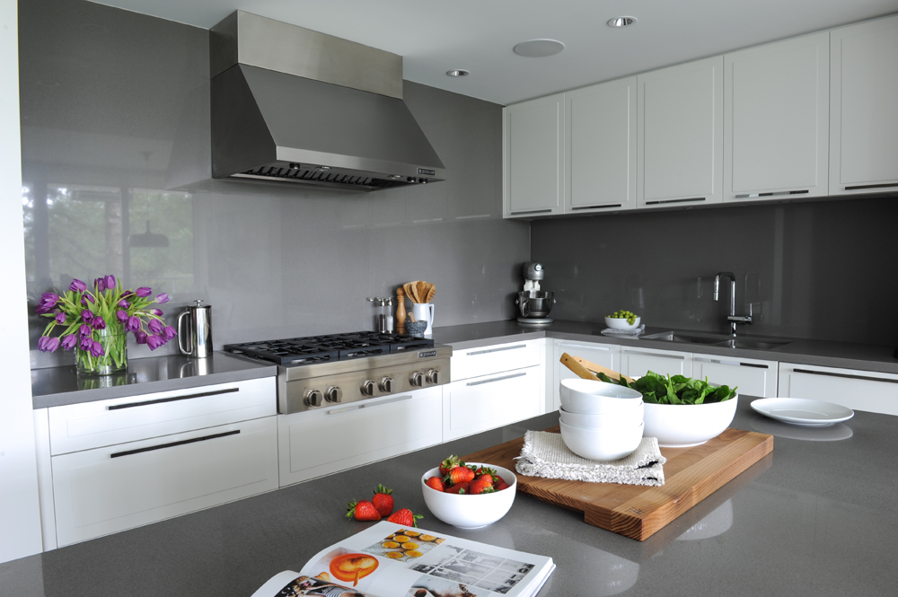 Kitchen grey glass walls, island top and white cupboards