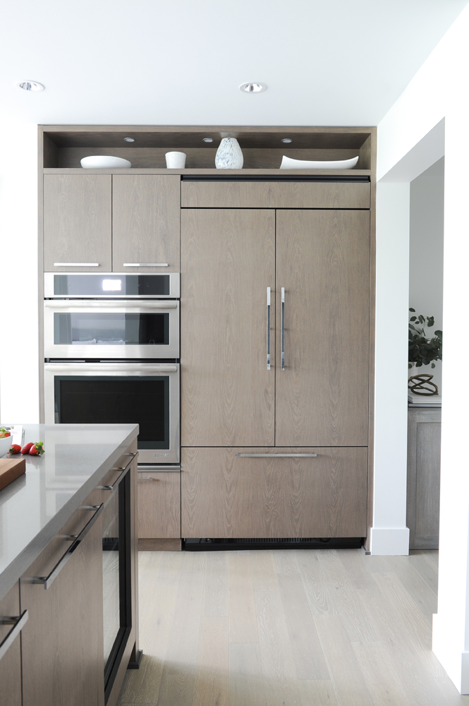 Beige built-in kitchen cabinetry with stainless-steel wall ovens
