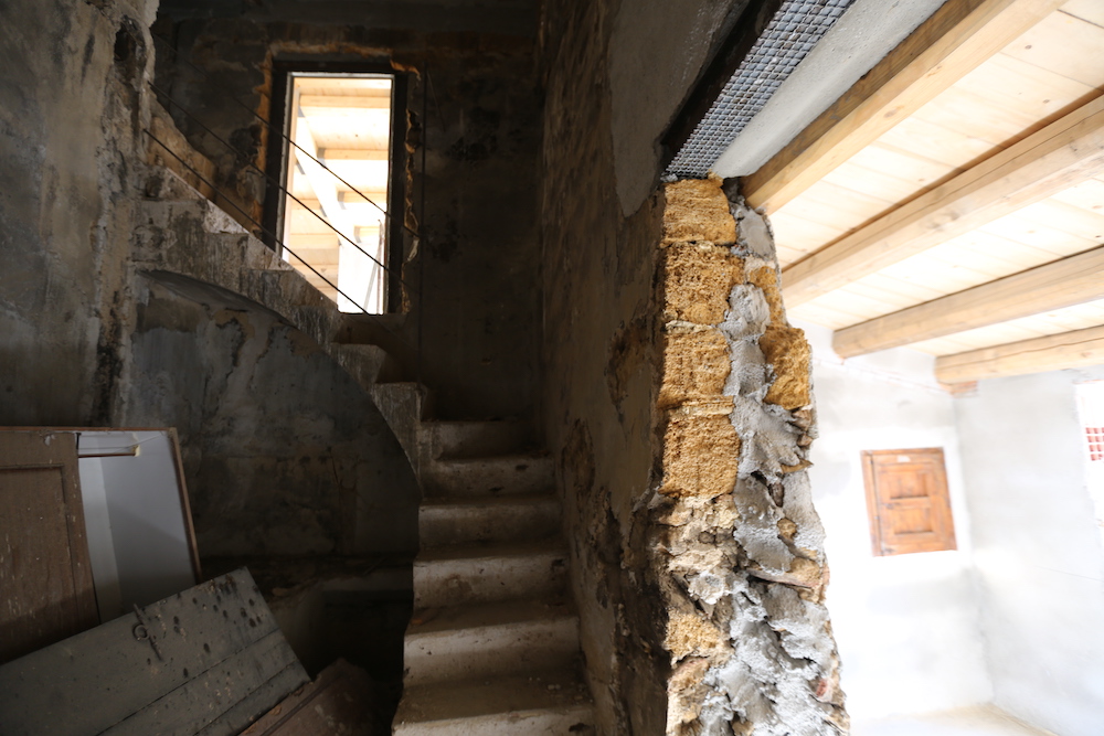 stone staircase in partially renovated home