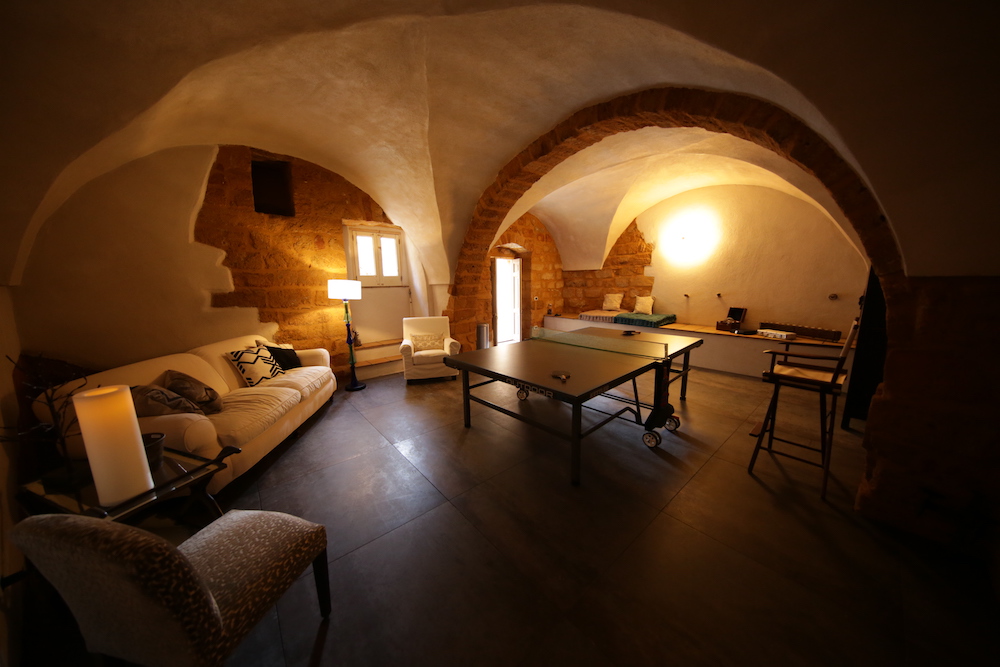 completed ping pong room with curved arches and exposed brick