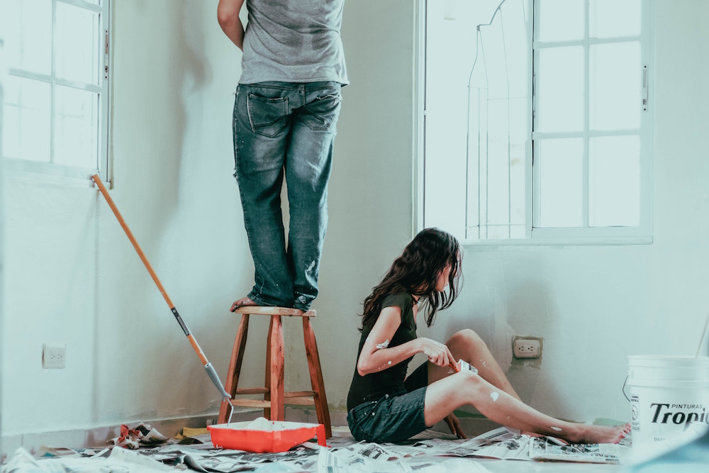 couple painting white room