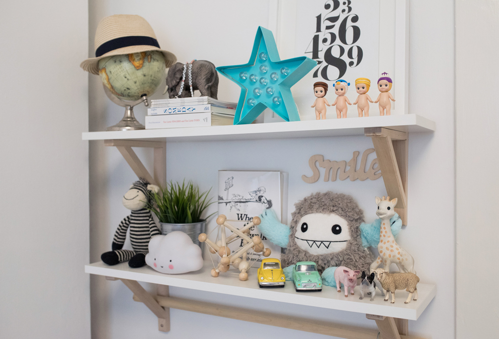 Open shelving in nursery room displaying toys and accents