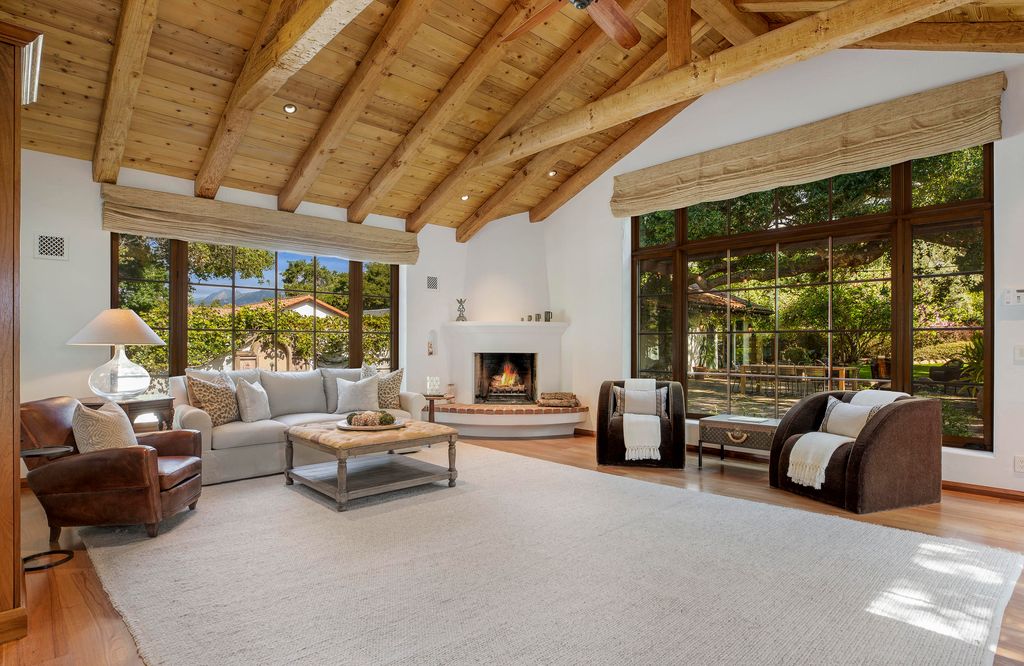 A spacious living room offering plenty of space, extra-high ceilings and massive picture windows