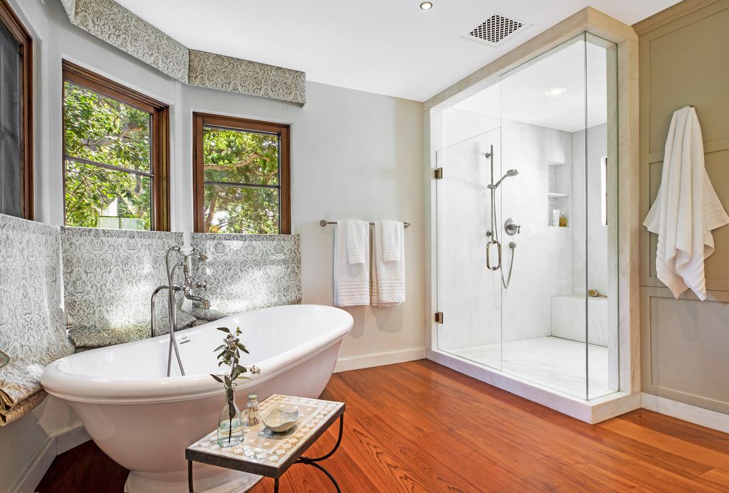 A huge freestanding tub and glass-enclosed steam shower in the master bathroom