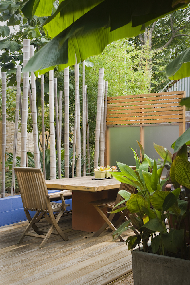 outdoor dining table framed by bamboo poles