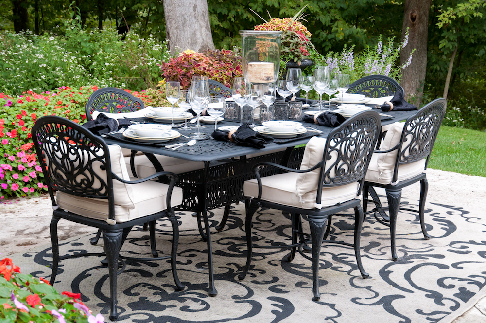 ornate black dining furniture in outdoor garden