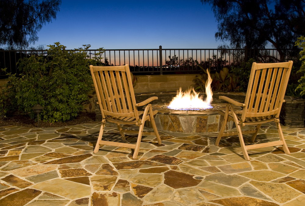 outdoor fire pit with seating to view the sunset