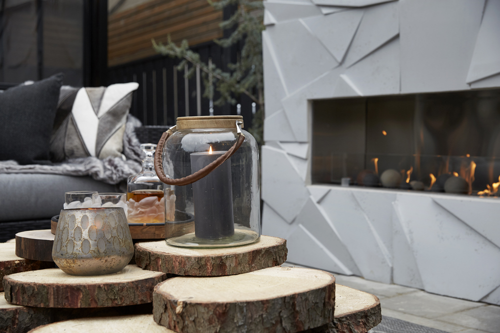 outdoor lounge area with grey outdoor fireplace