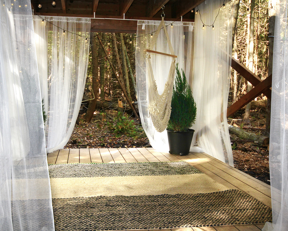 wood outdoor meditation area with white hammock