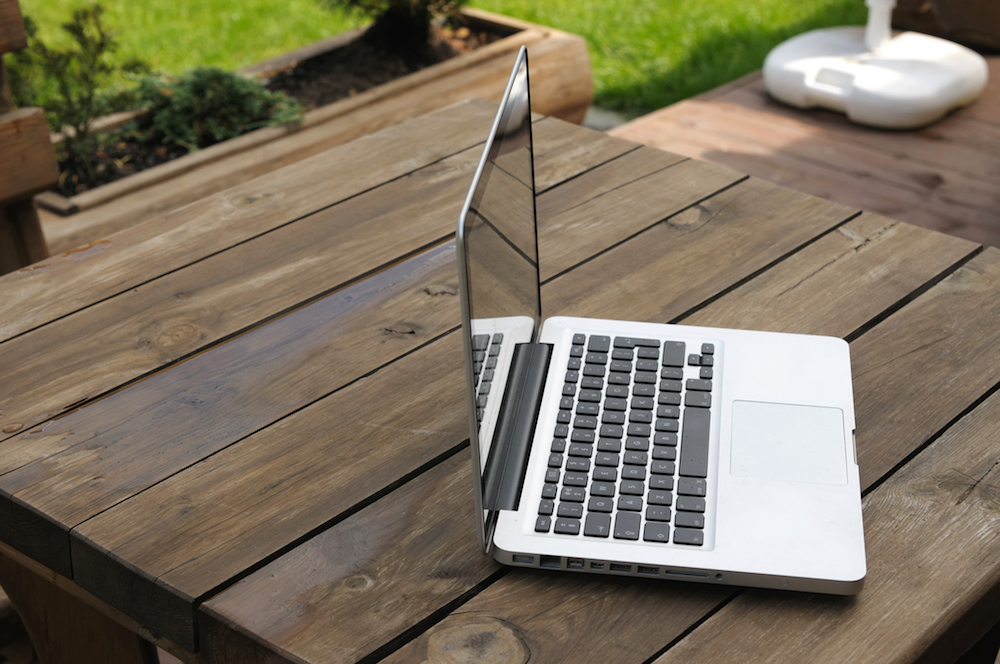 Laptop sitting on table in the outdoors
