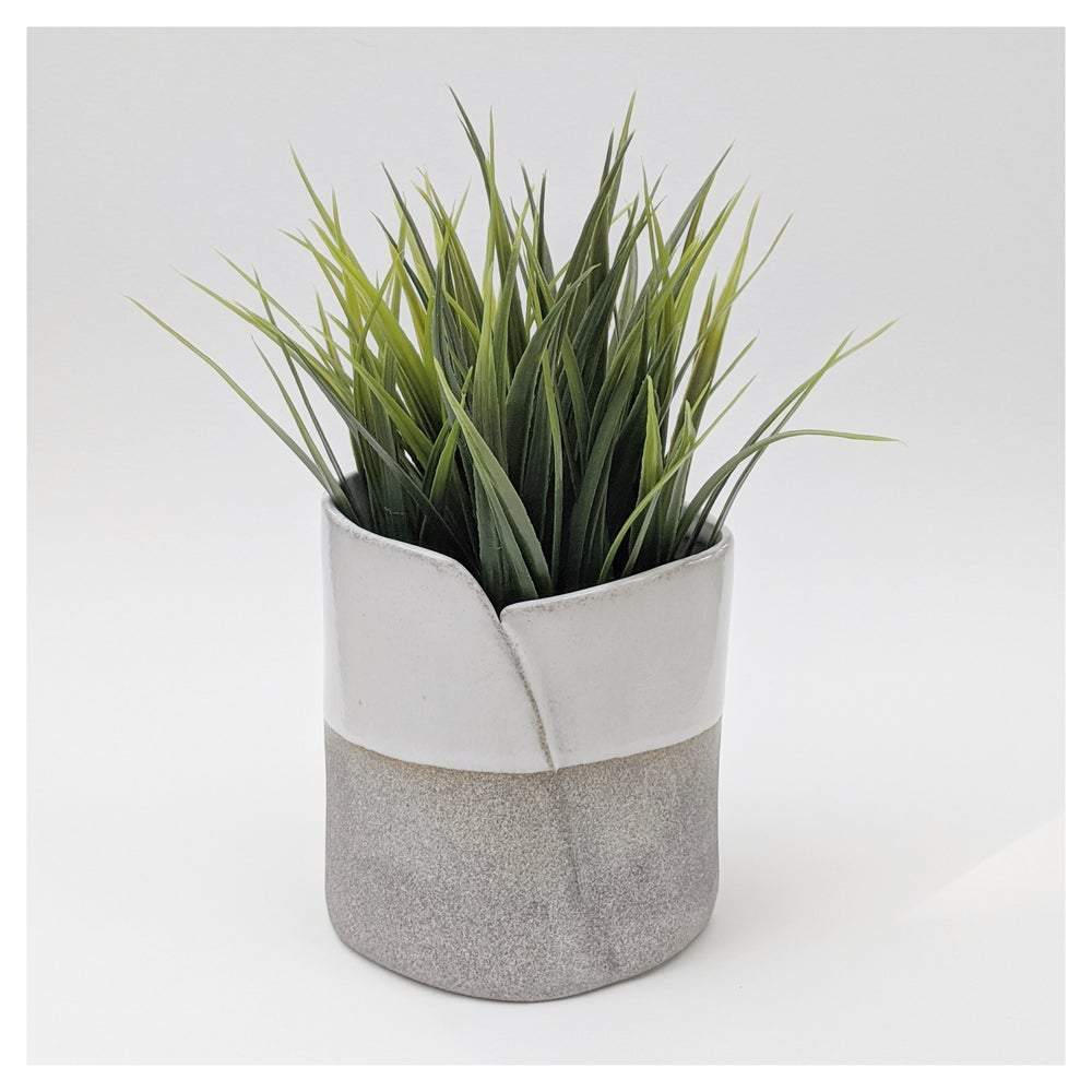 A gray and white ceramic planter