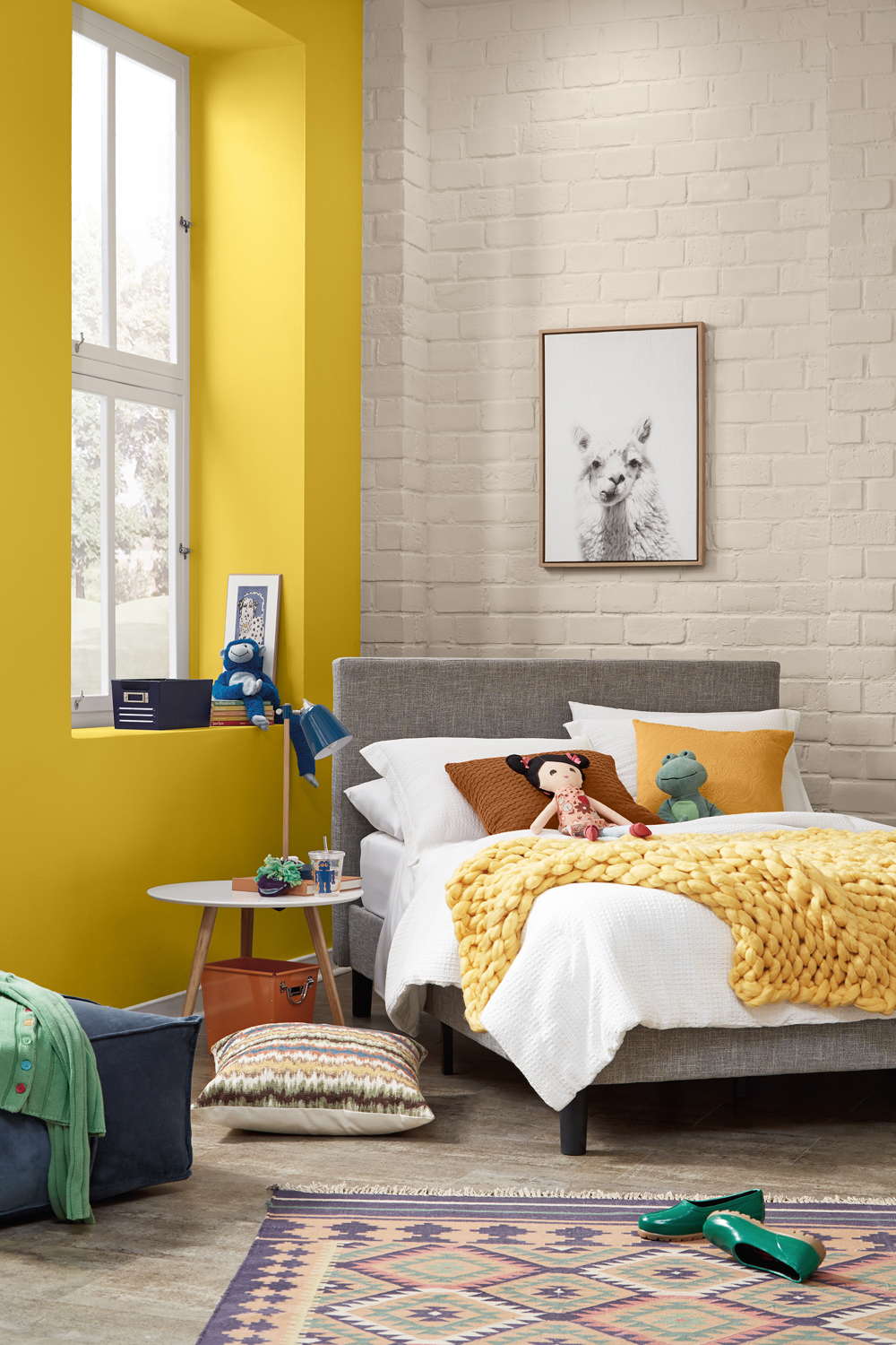 A cozy bedroom with a brick wall and a yellow accent wall