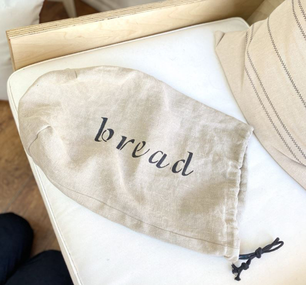 A white linen bread bag with the word 