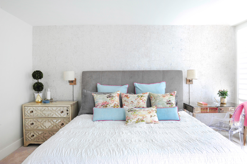 bedroom with grey headboard and blue toss cushions